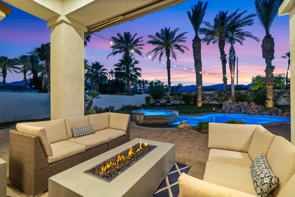a view of swimming pool with seating area and barbeque oven