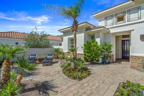 a kitchen with stainless steel appliances granite countertop a stove a sink and white cabinets