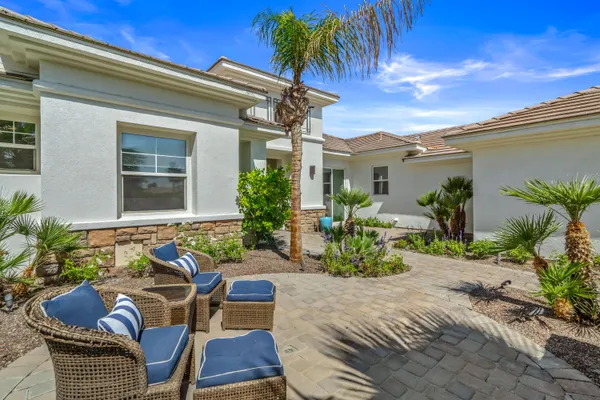 a kitchen with stainless steel appliances granite countertop wooden floor dining table and chairs