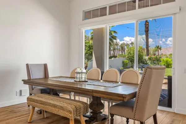a view of a dining room with furniture window and wooden floor