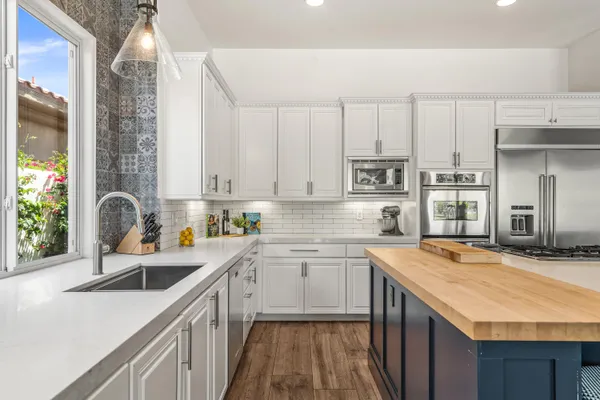 a bathroom with a granite countertop sink a toilet and shower