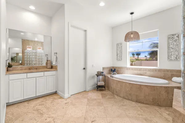 a kitchen with stainless steel appliances kitchen island granite countertop a table chairs and a refrigerator