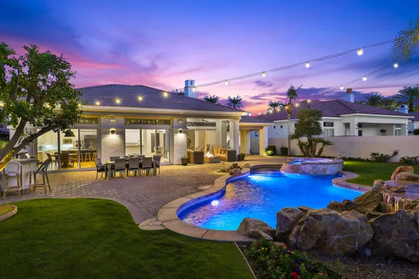 a view of a house with swimming pool and sitting area