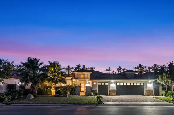a view of a backyard with swimming pool and sitting area
