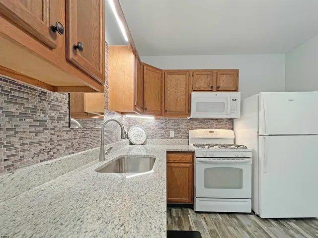 a view of a room with wooden floor and window