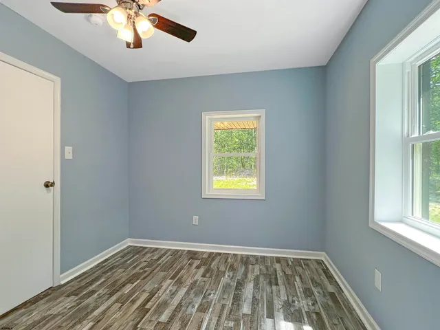 a view of a room with wooden floor and natural light