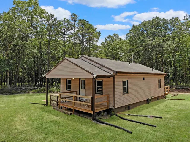 a backyard of a house with yard and trampoline