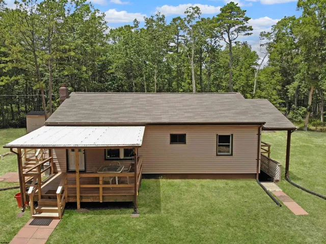 an outdoor view of house with backyard