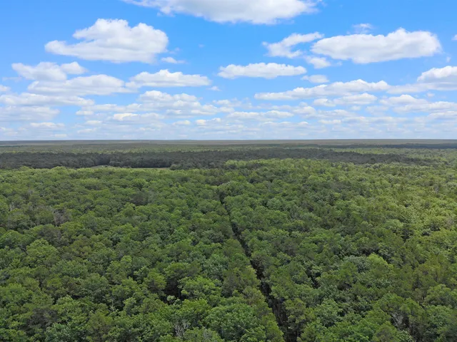 a view of a patio with table and chairs with wooden floor and fence