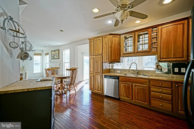 a open kitchen with granite countertop a sink appliances and cabinets
