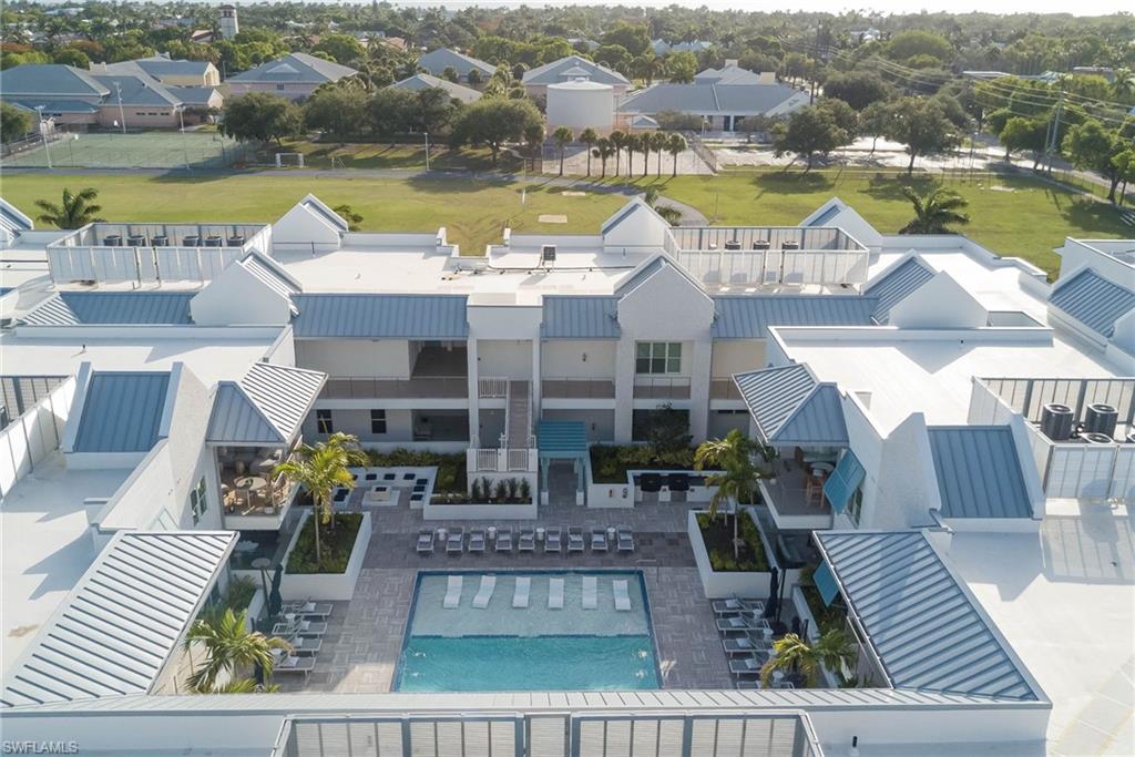 201 8th Street South, Unit 208 Naples, FL 34102 - Photo 1 of 39 a view of a swimming pool with a patio
