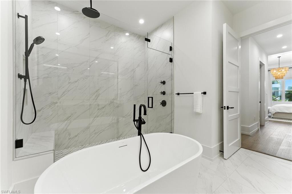 201 8th Street South, Unit 208 Naples, FL 34102 - Photo 16 of 39 Ensuite bathroom featuring recessed lighting, a freestanding tub, a marble finish shower, and marble finish floors