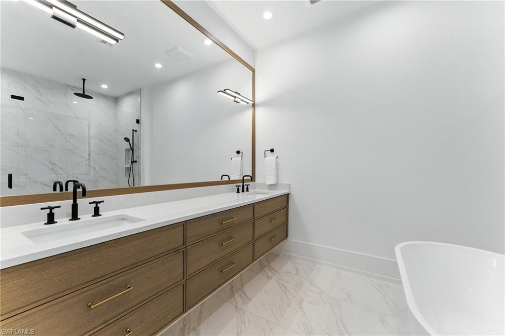 201 8th Street South, Unit 208 Naples, FL 34102 - Photo 18 of 39 Bathroom featuring a marble finish shower, double vanity, marble finish floors, a freestanding tub, and recessed lighting