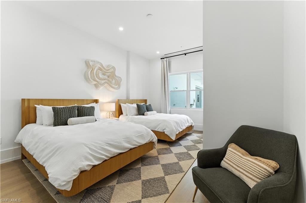 201 8th Street South, Unit 208 Naples, FL 34102 - Photo 19 of 39 Bedroom with light flooring and recessed lighting - two queen beds and large window with Southern exposure