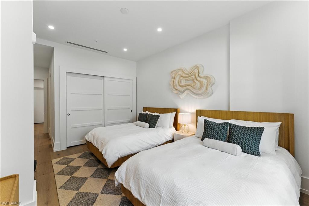 201 8th Street South, Unit 208 Naples, FL 34102 - Photo 20 of 39 Bedroom featuring wood finished floors, recessed lighting, and a closet