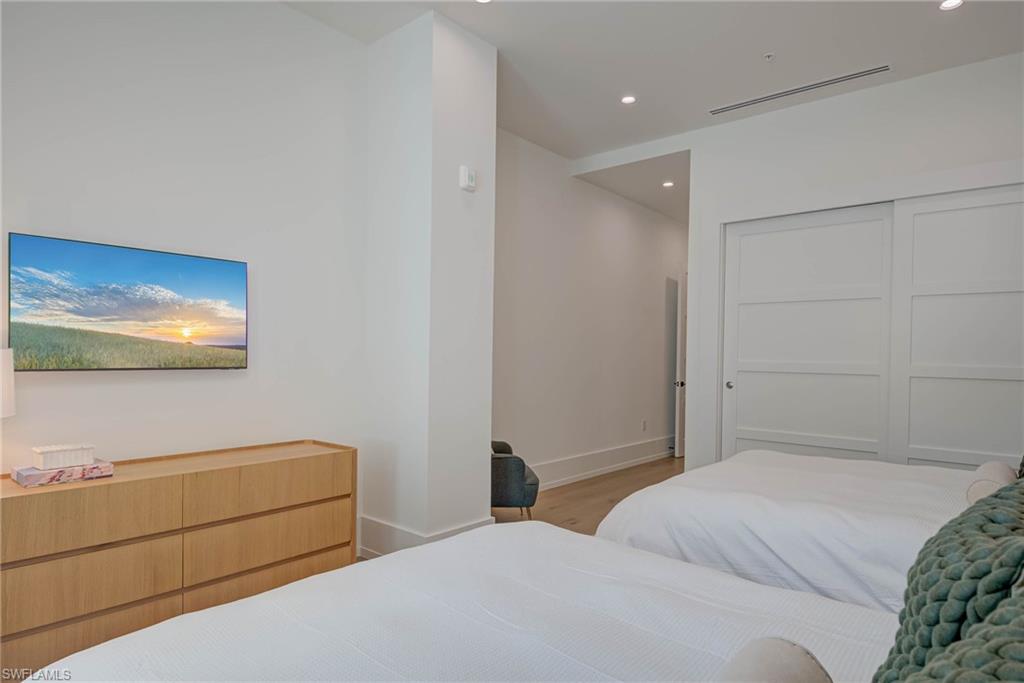 201 8th Street South, Unit 208 Naples, FL 34102 - Photo 21 of 39 Bedroom with wood finished floors, recessed lighting, and a closet