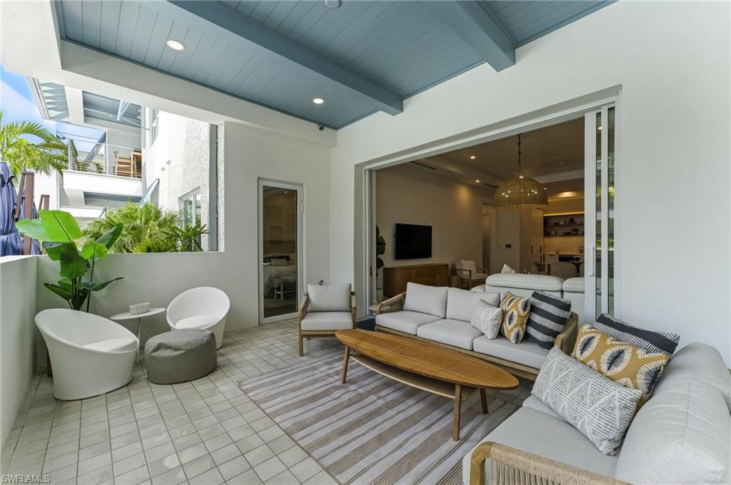 201 8th Street South, Unit 208 Naples, FL 34102 - Photo 24 of 39 Tiled living area featuring a wooden ceiling with exposed beams and recessed lighting - IMPACT SLIDERS AND WINDOWS - DOOR TO PRIMARY OFF PATIO - SOUTHERN EXPOSURE