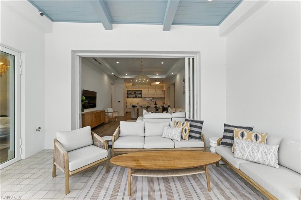 201 8th Street South, Unit 208 Naples, FL 34102 - Photo 25 of 39 Living room with recessed lighting, a chandelier, and a wooden ceiling with exposed beams