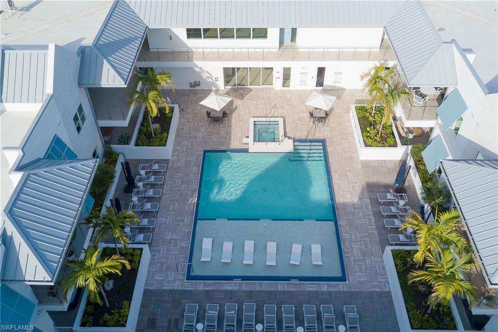 201 8th Street South, Unit 208 Naples, FL 34102 - Photo 26 of 39 Drone / aerial view of a pool area