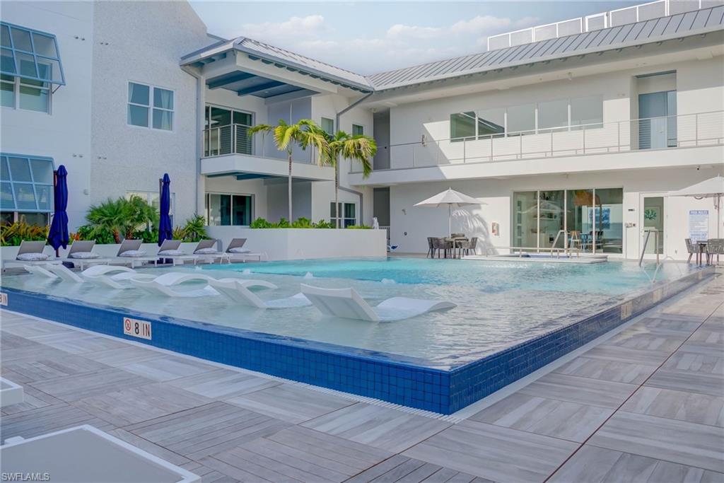 201 8th Street South, Unit 208 Naples, FL 34102 - Photo 28 of 39 Pool and hit tub on the 2nd floor amenity deck just steps from the unit patio