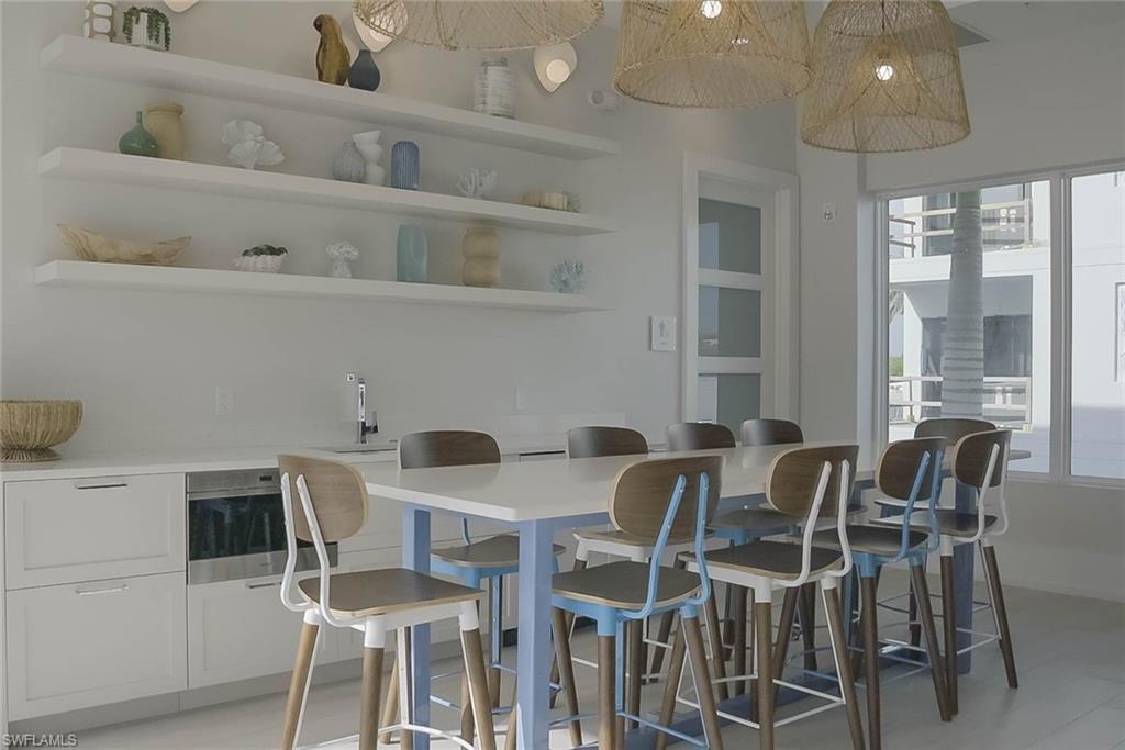 201 8th Street South, Unit 208 Naples, FL 34102 - Photo 29 of 39 Recreation room with golf simulator and bathrooms that lead to the sauna