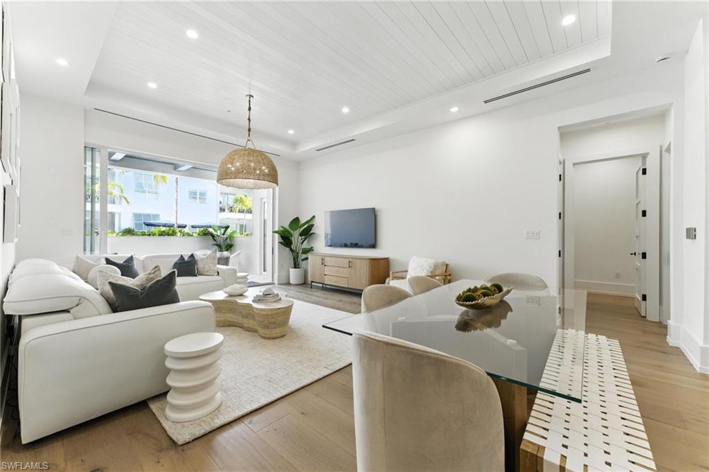 201 8th Street South, Unit 208 Naples, FL 34102 - Photo 6 of 39 Living area with a raised ceiling, light wood-style floors, recessed lighting, and wooden ceiling