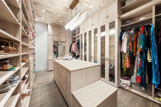 a bathroom with a granite countertop sink mirror vanity bathtub and a toilet