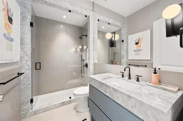 a spacious bedroom with a large bed and a chandelier