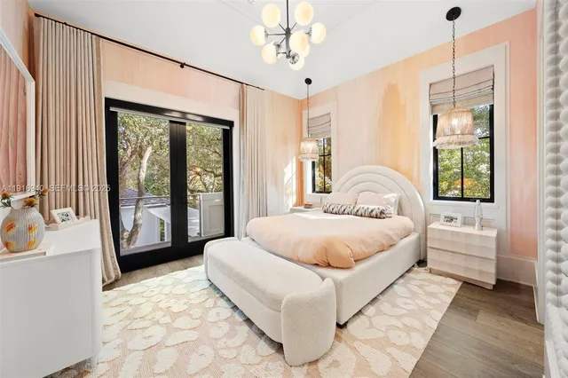 a living room with patio furniture and a chandelier