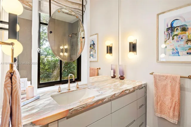 a en suite bathroom with a double vanity sink and a mirror