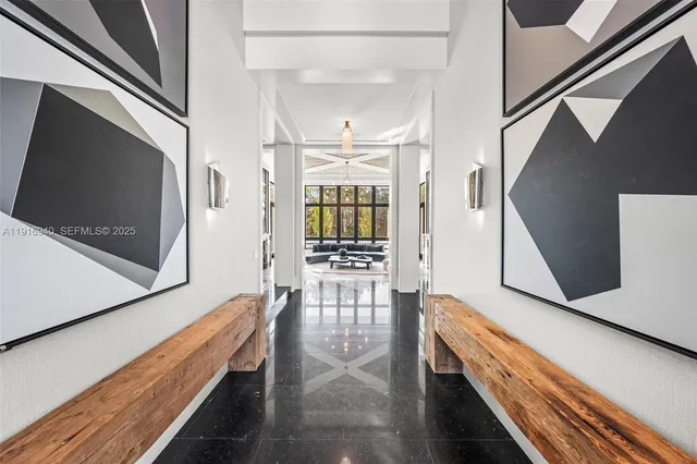 a living room with fireplace furniture and a large window