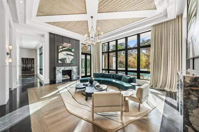 a kitchen with stainless steel appliances granite countertop a stove a refrigerator and a dining table with wooden floor