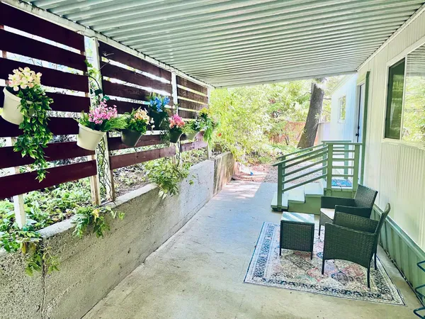 a view of a chairs and table in a patio