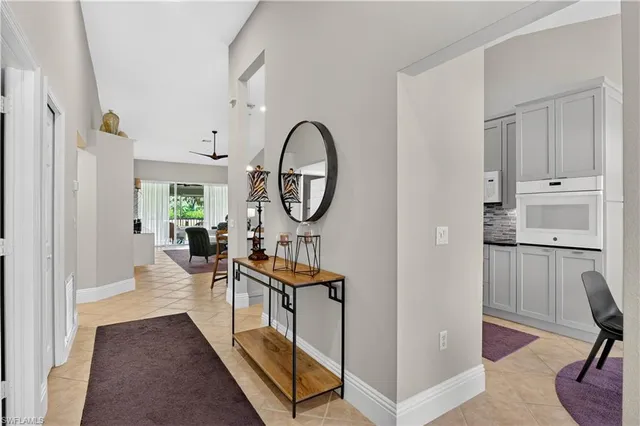 a view of a hallway with living room and furniture