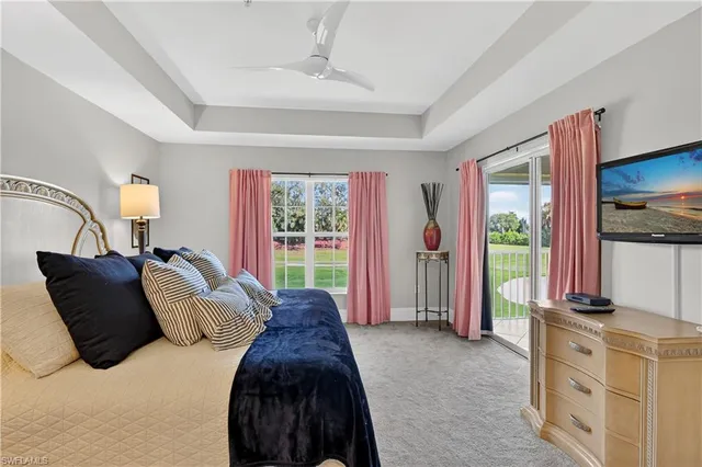 a bedroom with a bed closet and a flat tv screen