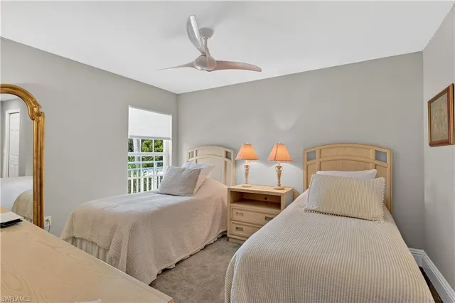 a bedroom with furniture and a large window