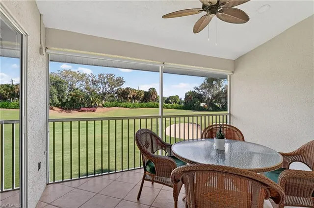 a balcony with table and chairs
