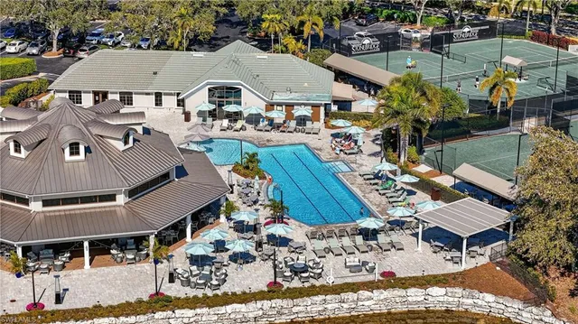 an aerial view of a house with a yard and lake view
