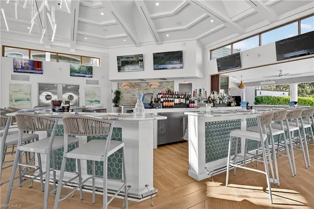 a kitchen with stainless steel appliances a sink a stove a table and chairs