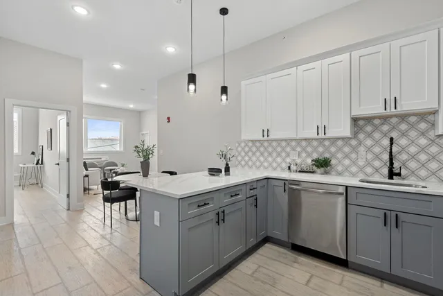 a kitchen with a sink window and cabinets