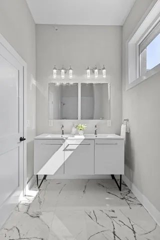 a bathroom with a sink and mirror