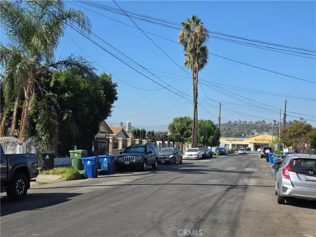 a view of street with parked cars