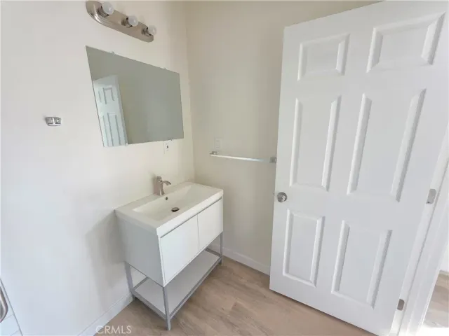 a bathroom with a sink a mirror and vanity