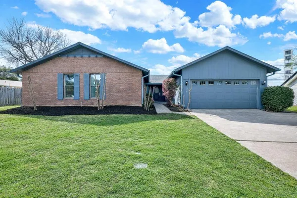 a front view of house with backyard and green space