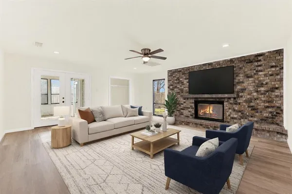a living room with fireplace furniture and a flat screen tv