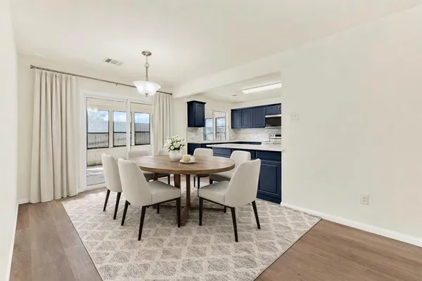 a view of a dining room with furniture window and wooden floor