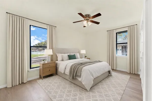 a spacious bedroom with a bed and a window