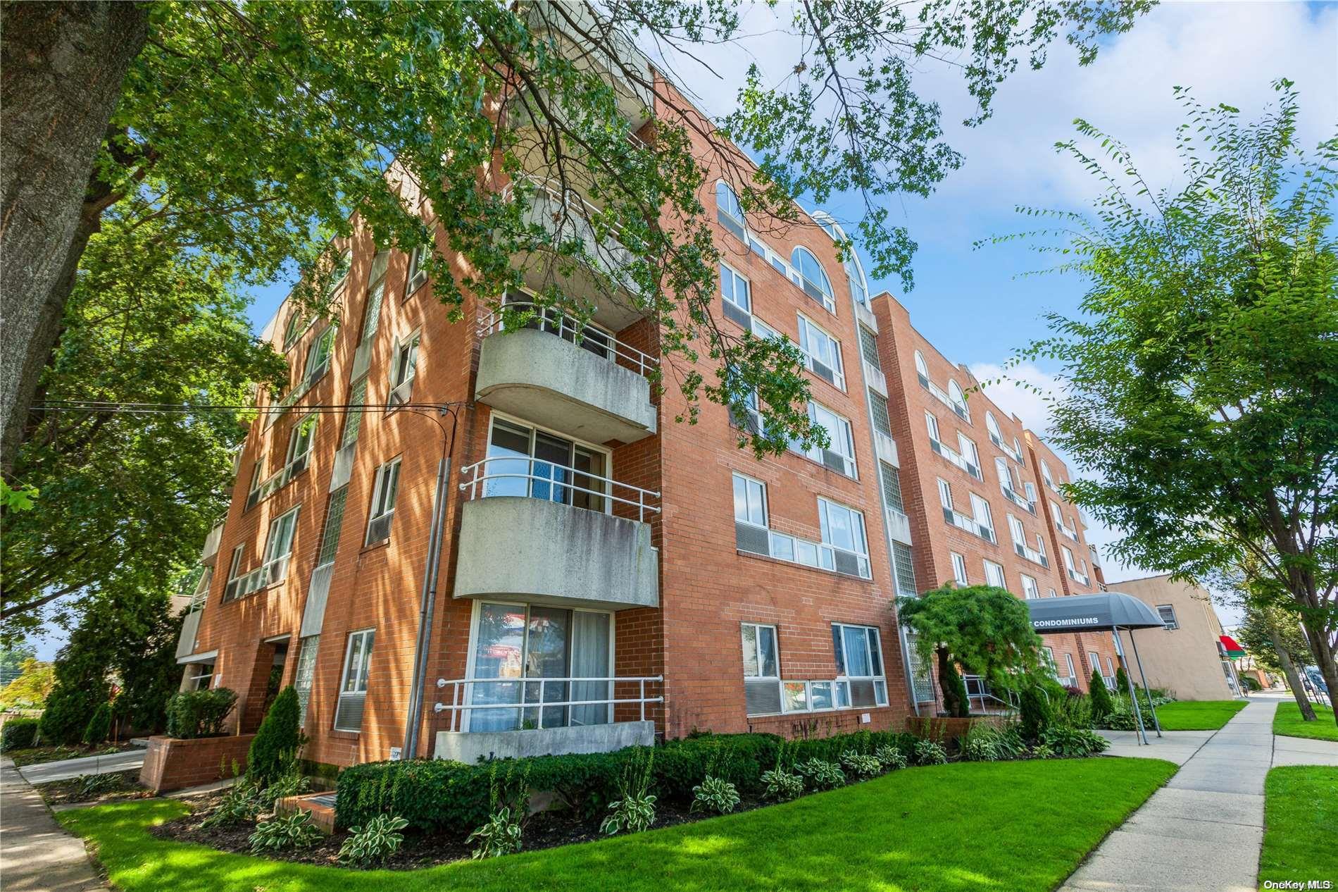 205 Mineola Boulevard, Unit 2J Mineola, NY 11501 - Photo 1 of 1 a view of a building with a yard