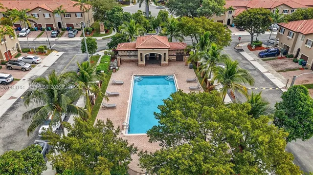 an aerial view of a house with yard swimming pool and outdoor seating