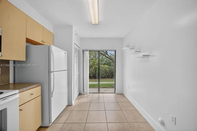 a view of a kitchen with a dishwasher cabinets and a wooden floor